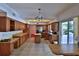 Spacious kitchen with wooden cabinets, center island, stainless steel appliances, and tile flooring at 2881 Se 41St Pl, Ocala, FL 34480
