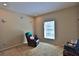 Cozy living room with a recliner, carpeted floors, and a window with natural light at 2881 Se 41St Pl, Ocala, FL 34480