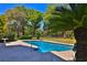 Backyard pool surrounded by lush greenery and landscaping at 2881 Se 41St Pl, Ocala, FL 34480