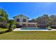 A beautiful backyard featuring a sparkling swimming pool, manicured lawn, and a home with charming balconies at 2881 Se 41St Pl, Ocala, FL 34480