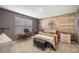 Bedroom features a wood accent wall and modern furnishings at 29496 Caspian St, Leesburg, FL 34748