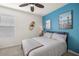 This bedroom features a striking blue accent wall and stylish decor at 29496 Caspian St, Leesburg, FL 34748