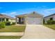 Charming single-Gathering home featuring a two-car garage and landscaped front yard at 29496 Caspian St, Leesburg, FL 34748