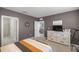 Bedroom featuring a dresser and a telescope in an adjacent room at 29496 Caspian St, Leesburg, FL 34748