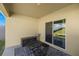 Cozy outdoor patio features furniture, and a sliding door entry into the home at 29496 Caspian St, Leesburg, FL 34748