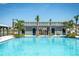 A community pool is bordered by lounge chairs and a covered seating area for residents at 29496 Caspian St, Leesburg, FL 34748