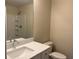 Bright bathroom featuring a modern vanity, toilet, and shower with built-in shelves at 2983 Se 145Th Pl, Summerfield, FL 34491