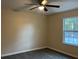Bedroom featuring a ceiling fan, hardwood floors, and natural light from a window at 2983 Se 145Th Pl, Summerfield, FL 34491
