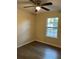 Bedroom featuring a ceiling fan, hardwood floors, and natural light from a window at 2983 Se 145Th Pl, Summerfield, FL 34491