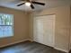 Bedroom features a window with natural light and closet with sliding doors at 2983 Se 145Th Pl, Summerfield, FL 34491