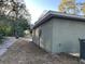 View of the back right corner of a one-story house with an AC unit and an electrical box on the side at 2983 Se 145Th Pl, Summerfield, FL 34491