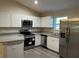 Elegant kitchen with stainless steel appliances, granite countertops, and lots of cabinet space at 2983 Se 145Th Pl, Summerfield, FL 34491
