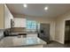 Contemporary kitchen with stainless steel refrigerator and view to breakfast area and door to side yard at 2983 Se 145Th Pl, Summerfield, FL 34491
