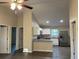 Bright, open kitchen with white cabinets, stainless steel appliances, and granite countertops at 2995 Se 145Th Pl, Summerfield, FL 34491