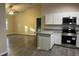 Open-concept living area next to a modern kitchen with stainless steel appliances at 2995 Se 145Th Pl, Summerfield, FL 34491