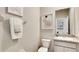 Well-lit half bathroom featuring a modern sink, granite countertops, and neutral decor at 3067 Canopy Oak Blvd, Wildwood, FL 34785