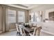 Elegant dining room with patterned drapes, neutral tones, and decorative artwork at 3067 Canopy Oak Blvd, Wildwood, FL 34785