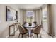 Cozy dining room features modern decor, neutral colors, and backyard views at 3067 Canopy Oak Blvd, Wildwood, FL 34785