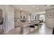 Bright kitchen boasts stainless appliances, granite countertops, and a breakfast bar at 3067 Canopy Oak Blvd, Wildwood, FL 34785