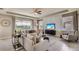 Relaxing living room featuring plush seating, backyard views, and stylish decor at 3067 Canopy Oak Blvd, Wildwood, FL 34785