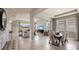 Open-concept design showcasing living, dining and entry with tile flooring and modern accents at 3067 Canopy Oak Blvd, Wildwood, FL 34785