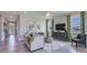 Inviting living room with tile flooring, neutral decor, large windows with decorative curtains, and comfortable seating at 3084 Canopy Oak Blvd, Wildwood, FL 34785