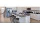 Bright kitchen features stainless steel appliances, granite counters, and a spacious island at 3088 Canopy Oak Blvd, Wildwood, FL 34785