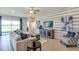 Cozy living room with stylish furniture, decorative accents, and sliding glass doors to patio at 3088 Canopy Oak Blvd, Wildwood, FL 34785