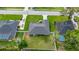 A bird's eye view showcases a house with a grey roof in a community of landscaped yards at 3203 Se 23 Ter, Ocala, FL 34471