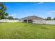 Large backyard with well-maintained lawn, fencing, and the house exterior at 3203 Se 23 Ter, Ocala, FL 34471