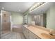Bathroom featuring double sinks, a large mirror, a shower, and a tub at 3203 Se 23 Ter, Ocala, FL 34471
