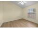 A cozy bedroom that features a ceiling fan, window with blinds, and hardwood floors at 3203 Se 23 Ter, Ocala, FL 34471