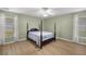 Bedroom featuring a four poster bed and abundant natural light from two windows at 3203 Se 23 Ter, Ocala, FL 34471