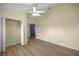 An empty bedroom featuring hardwood floors, a ceiling fan, and a walk-in closet at 3203 Se 23 Ter, Ocala, FL 34471