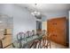 Bright dining room with glass table, modern chandelier, and wood cabinet at 3203 Se 23 Ter, Ocala, FL 34471