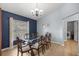 Dining room with glass table, chandelier, wood flooring, and access to laundry room at 3203 Se 23 Ter, Ocala, FL 34471