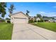 Charming single-story home with a paved driveway and attached two-car garage at 3203 Se 23 Ter, Ocala, FL 34471