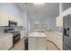 Neutral kitchen with stainless steel appliances, island, and lots of countertop space at 3203 Se 23 Ter, Ocala, FL 34471