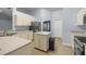 Spacious kitchen with island and stainless steel appliances leading into dining room at 3203 Se 23 Ter, Ocala, FL 34471