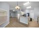 Open living area with modern lighting, wood floors, and access to kitchen at 3203 Se 23 Ter, Ocala, FL 34471