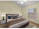 Comfortable bedroom with a ceiling fan, window with blinds, and cozy furnishings at 3203 Se 23 Ter, Ocala, FL 34471