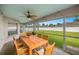 Relaxing screened patio with wooden furniture and a backyard view at 3203 Se 23 Ter, Ocala, FL 34471