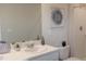 Bathroom featuring a single sink vanity, toilet, and a shower with glass doors at 3282 Bertram Rd, Wildwood, FL 34785