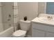 Well-lit bathroom with a shower-tub combo, a toilet, and a single sink vanity at 3282 Bertram Rd, Wildwood, FL 34785