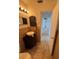Bathroom with a unique vessel sink, decorative tile, and an open doorway at 333 Marion Oaks Dr, Ocala, FL 34473