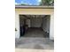 Spacious garage interior with washer/dryer hookups, shelving, and bright lighting at 333 Marion Oaks Dr, Ocala, FL 34473