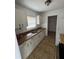 Functional kitchen featuring white cabinets, a double sink, and a view from the window at 333 Marion Oaks Dr, Ocala, FL 34473