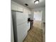 Efficient kitchen with a white refrigerator and view into an adjacent room at 333 Marion Oaks Dr, Ocala, FL 34473