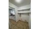 Cozy laundry area with shelving and tile flooring next to the kitchen at 333 Marion Oaks Dr, Ocala, FL 34473