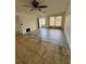 Bright living room with wood-look flooring, ceiling fan, and a large window at 333 Marion Oaks Dr, Ocala, FL 34473